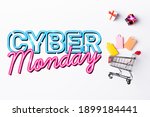 Top view of small gift boxes and shopping bags near toy cart and cyber monday lettering on white background