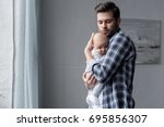 Handsome Father Hugging His...