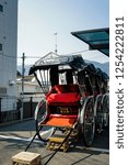 Small photo of Kyoto/ Japan - March 24th 2014 - Japanese rickshaw or called as Jinrikisha in japanese with the beautiful red and black colour and details of traditional Japanese art style