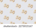 Pattern made of gold colored number fifty on a blue background. 