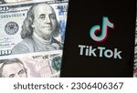 Small photo of Phitsanulok Thailand - April 23,223 : Application Tiktok icon social network smartphone on US dollar background. The TikTok wars US and China, parent company ByteDance are feuding over the app.