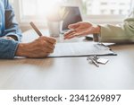 Small photo of Real estate agent or realtor landlord advice buyer client to sign mortgage document. close-up focus on hand of tenant holding pen signing paperwork.