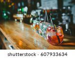 Alcoholic cocktail row on bar table, colorful party drinks 