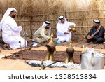 Small photo of Abu Dhabi/UAE - January 12 2019: Arabic men gather together and drink coffee seating in traditional Bedouin tent. Arabic hospitality concept
