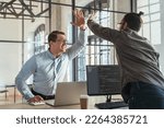 Small photo of Colleagues coders giving high five to each other celebrating successful start-up launch. Programmers rejoice at the successful launch of their product.