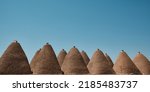 Small photo of Traditional mud brick or adobe made beehive houses. Harran, major ancient city in Upper Mesopotamia, nowadays is a district in Sanliurfa province, Turkiye. Roofs of beehive houses opposite clear sky