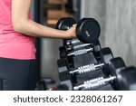 Small photo of Rows of stainless dumbbell in the gym, Sports dumbbells in modern sports club.
