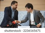 Small photo of Bucharest, Romania - December 09, 2022: Ciprian Ciucu (L), sector 6 mayor, and Nicusor Dan, Bucharest Mayor, shake hands after the signing a non-refundable European funds contract for waste management