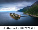 Aerial view of the Husoy fishing village on the Senja Island, northern Norway. The village covers the entire island of Husoy which is located in the Oyfjorden at the northwest coast of Senja.