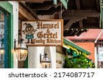 Small photo of Helen, USA - October 5, 2021: Bavarian village of Helen, Georgia street with sign entrance for famous Hansel and Gretel chocolate factory candy kitchen with traditional architecture building