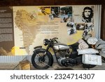 Small photo of Puerto Blest, Argentina, February 22, 2023: Information Table with Ernesto Che Guevara, famous Argentine Rebel Leader, his equipment and motorcycle at Paso International Perez Rosales Border Crossing