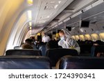 Small photo of MIAMI, USA - APRIL 26, 2020: Covid 19 coronaviruse. Stewardess in protective mask on the plane board. Evacuation repatriation. Flying during coronaviruse pandemic. Special flight returns US citizens