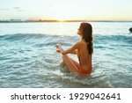    woman in a swimsuit sits on...