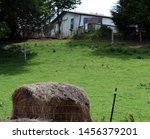 A Hay Bale In Front Of A House...