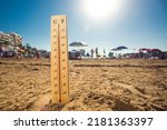 Small photo of Hot weather. A temperature scale on a beach shows high temperatures during a heat wave. Hot summer and climate concept