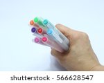 colorful pens in hand | Shutterstock . vector #566628547