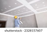 Small photo of Craftsman working with plaster gypsum ceiling for interior build gypsum board ceiling in construction sit.
