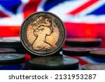 Small photo of Queen Elizabeth II 2 New Pence Coin 1979 UK Flag Background Macro Close Up