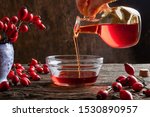 Pouring Rose Hip Seed Oil Into...