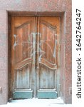 Small photo of Urban unkempt postpaid brown door, Abandoned facade of a modern building.