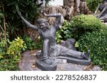 Small photo of Bangkok, Thailand- 8 March 2023 : Contorted hermit at Wat Pho, posture 80 Contortion, fixing the breast carved line.