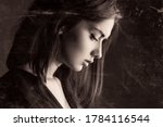 Small photo of Sadness melancholy portrait, beautiful young girl. Side face close-up headshot of serious unhappy female teenage, dark vintage artistic effect