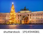 Arch of the main headquarters on Palace Square and a New Year tree in St. Petersburg in the light of morning lanterns