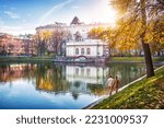 Small photo of Patriarch's Ponds on an autumn sunny day and a couple in love on the shore, Moscow