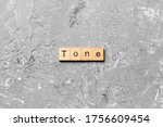 tone word written on wood block. tone text on cement table for your desing, concept.