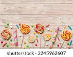 Tasty appetizing Party Accessories Happy Birthday Sweet. Different types of candies on colored background, copy space. Colorful birthday party background.