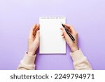 Small photo of Woman hand with pencil writing on notebook. Woman working on office table. Female hand holding pencil and sketchbook. Mock-up Concept.