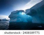 Small photo of In the frigid waters of Glacier Lagoon, a colossal iceberg commands attention with its sheer size and striking formations, a testament to the raw power of nature in Greenland's icy realm.