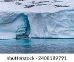 Small photo of Majestic Antarctic icebergs dot the frigid waters, a stark reminder of Earth's fragile balance. Amidst boat tourism, they silently narrate the urgency of combating climate change.