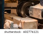 Small photo of Close up of a straight router bit cutting a groove or rabbet in a piece of oak. The machine for sampling the groove in a wooden beam. in progress close