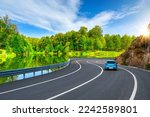 Small photo of road landscape in beautiful nature. Stunning highway view in green nature. Car traveling on road in colorful forest. Sunny vacation road in spring. extraordinary highway passing by the lake in summer.