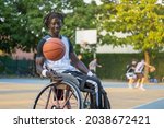 Small photo of African man with a disability caused by polio playing basketball, champion athlete having disability in a wheelchair, concept of determination and mental toughness