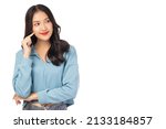 Small photo of Thinking young asian woman standing isolated over white background Looking aside to copy space with happy and smile face Thoughtful female youngster keeps fore finger near cheek being deep in thoughts
