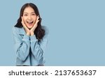 Small photo of Surprised happy beauty asian woman looking camera in excitement Expressive facial expressions Presenting a product Beautiful girl act like a telling something Isolated on light blue background