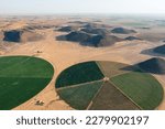 Small photo of Irrigation systems create green circular fields in the dry Arabian desert