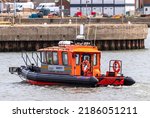 Small photo of LOWESTOFT, SUFFOLK, UK â€“ JULY 30, 2022: CRC LODESTAR, an 11 metre cabin RIB safety boat enters Lowestoft's outer harbour during the International Smack Race Festival.