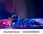 Small photo of In selective focus of Pro DJ controller.The DJ console CD mp4 deejay mixing desk Ibiza house music party in nightclub with colored disco lights.