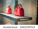Premium luxury Fashion brand name purse on shelf at shopping mall.