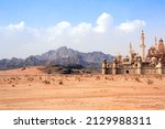 Small photo of A fabulous lost city in the desert. Fantastic oriental town in the sands. Fantasy landscape with rocky mountains and fairytale city