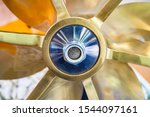 Small photo of Screw propeller on the ship. Boat service. Screw propeller closeup. Small ship airscrew. New ship propeller.External skrev for the boat. Spare parts for small ships. External engine for the boat