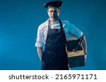 Small photo of Dismissal chef man. Cook restaurant with box. Cook very upset dismissal. Sad chef in cafe kitchen. Dismissal staff in restaurant business. Boxes and kitchen utensils in hand guy chef.