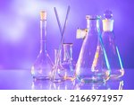 Small photo of Laboratory test tubes. Flasks on table. Test tubes for medical research. Dishes for medical experiments. Glass medical flasks on violet. Laboratory glassware. Laboratory flask for science.