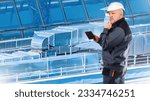 Small photo of Man engineer. Ventilation shafts. Worker with tablet thought. Control of ventilation system. Concept of installation of galvanized ventilation shafts. Man engineer scratching chin.