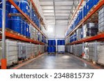 Small photo of Logistic warehouse. Barrels for chemical storage. Plastic and metal tanks on racks. Storage area in industrial building. Hangar with multi-tier pallet racks. Logistics warehouse interior