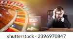 Small photo of Man lost at casino. Roulette is game of chance. Guy is gamer sitting clutching head. Man went bankrupt due to gambling addiction. Gambling addict lost money. Casino addiction. Upset gambling addict