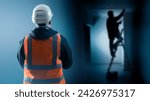 Small photo of Man foreman watches work electrician. High-voltage network repair specialist on stepladder. Foreman construction team back to camera. Work on electrification building. Foreman in reflective vest